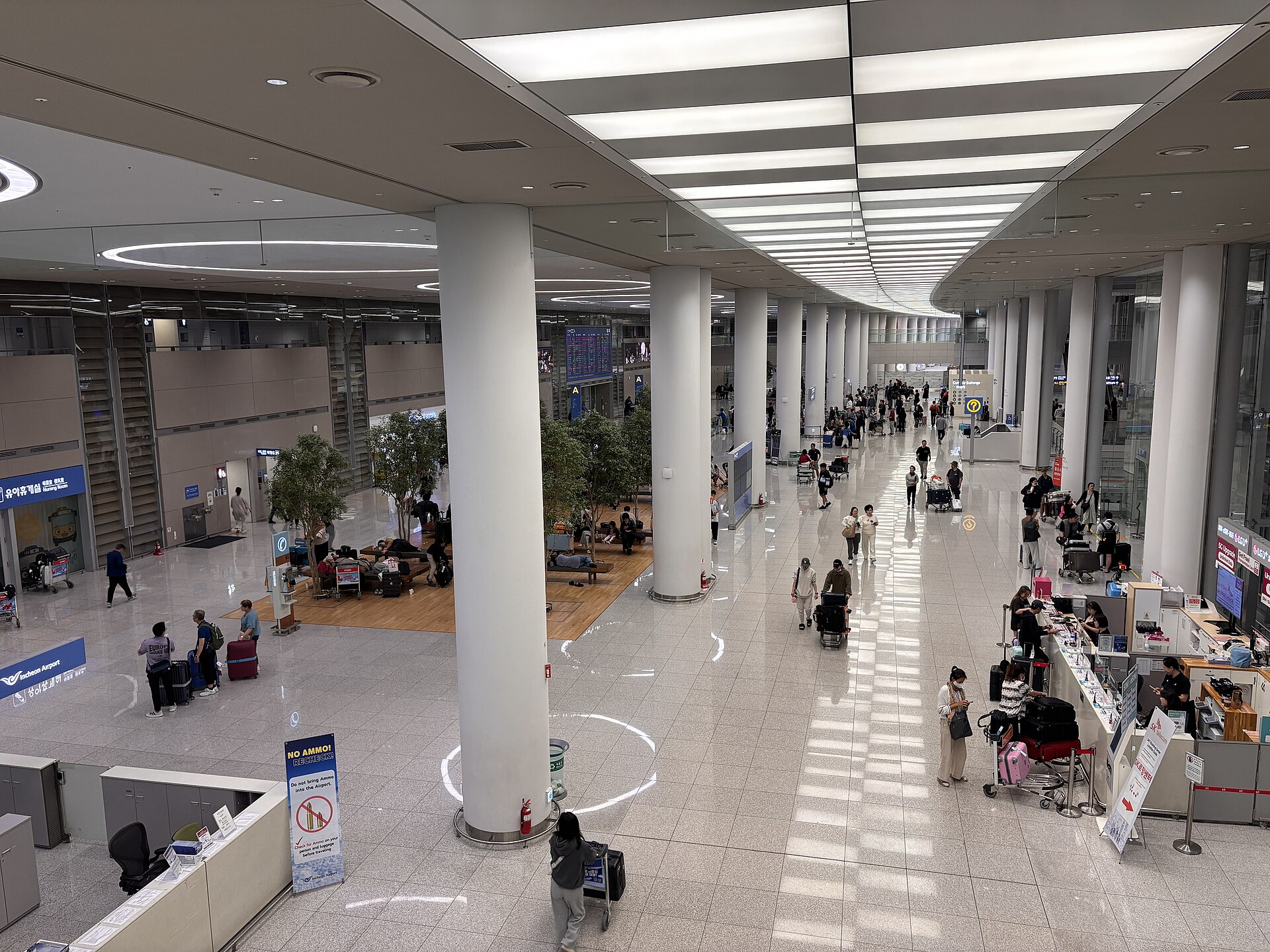 Travelers inside the Incheon International Airport terminal