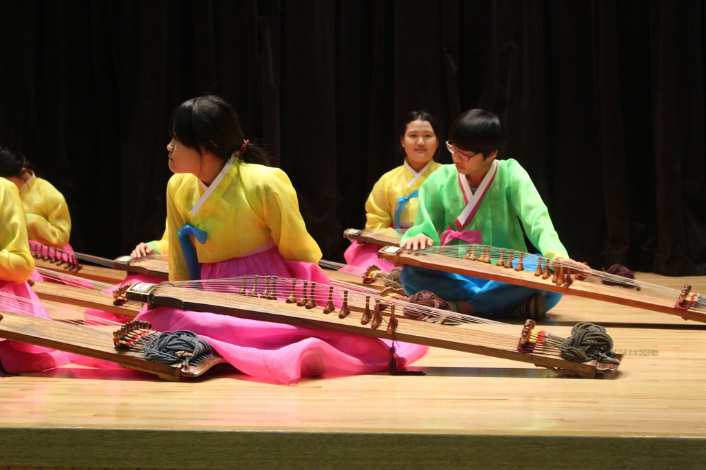 Musicians in hanbok playing traditional instruments
