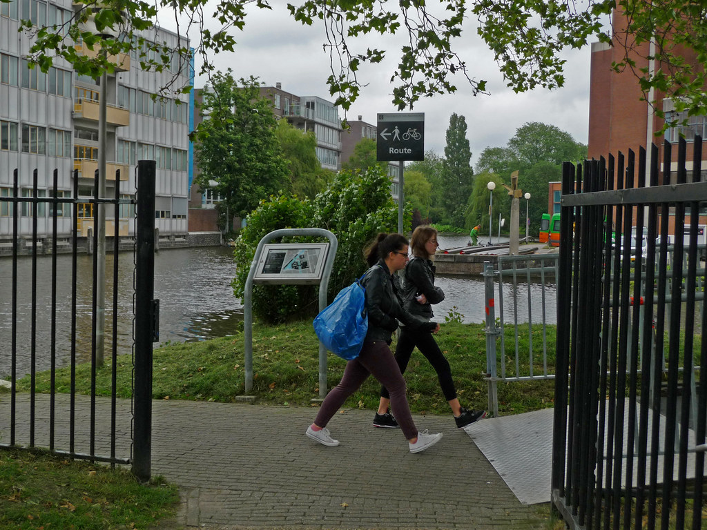 Two students walking across campus