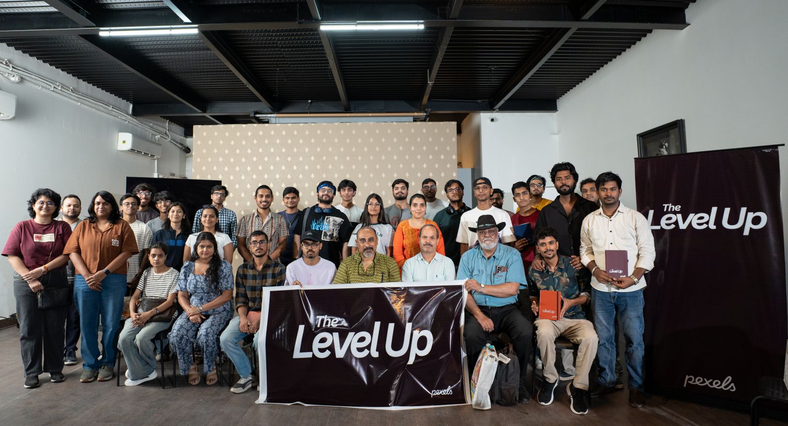Program participants holding a banner for a group photo
